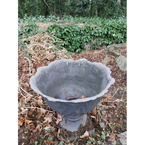 1068 - Pair of cast iron garden urns decorated with acanthus leaves, mounted on stone bases. {33 cm H x 60 ... 