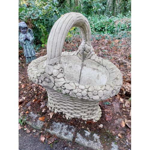 1069 - Weathered composition planter in the form of a basket. {74 cm H x 75 cm W x 57 cm D}.