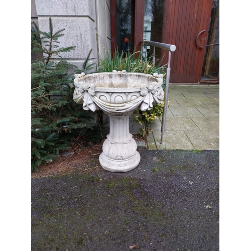 1073 - Weathered composition garden urns decorated with swags and bows. {81 cm H x 72 cm W}.