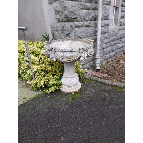 1073 - Weathered composition garden urns decorated with swags and bows. {81 cm H x 72 cm W}.