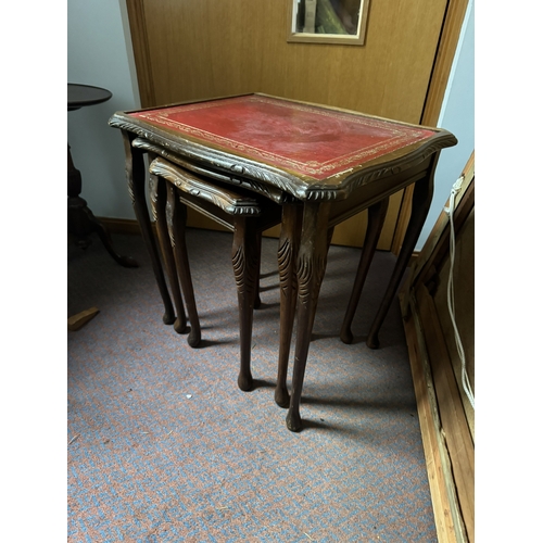 1087 - Nest of three 1970's mahogany tables with tooled leather tops, raised on Queen Anne legs. { 53cm H X... 