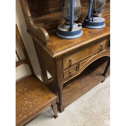 1093 - 1920's oak Welsh dresser, the super structure with three shelves above ten spice drawers over three ... 