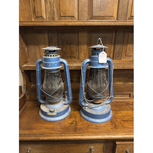 1094 - Two  hurricane lamps. { 43cm H X 21cm Dia }.