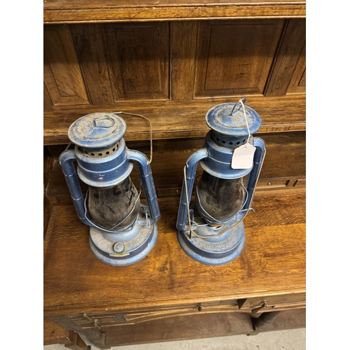 1094 - Two  hurricane lamps. { 43cm H X 21cm Dia }.