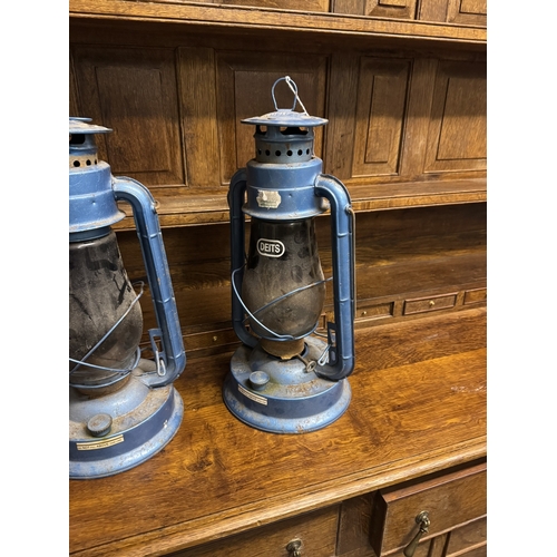 1094 - Two  hurricane lamps. { 43cm H X 21cm Dia }.