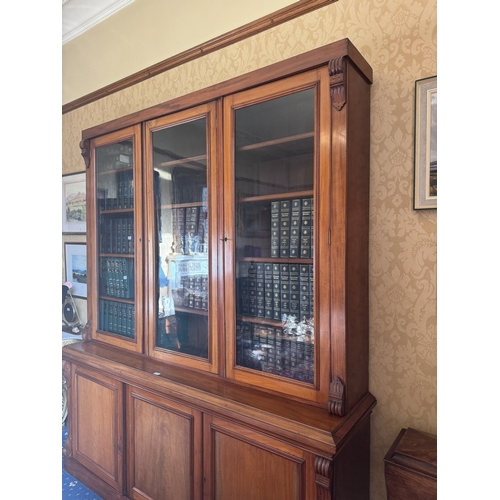 115 - Victorian mahogany three door bookcase with three glazed doors above three blind doors. {245 cm H x ... 