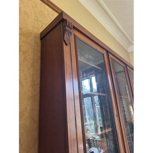 115 - Victorian mahogany three door bookcase with three glazed doors above three blind doors. {245 cm H x ... 