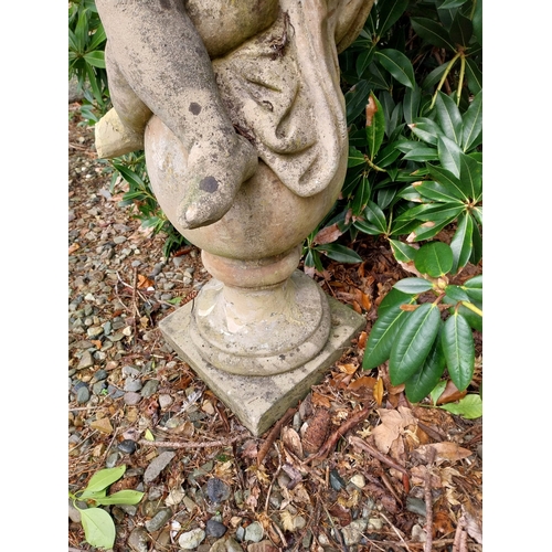 12 - Weathered composition figure of Cherub with musical instrument. {100 cm H x 46 cm W x 30 cm D}.