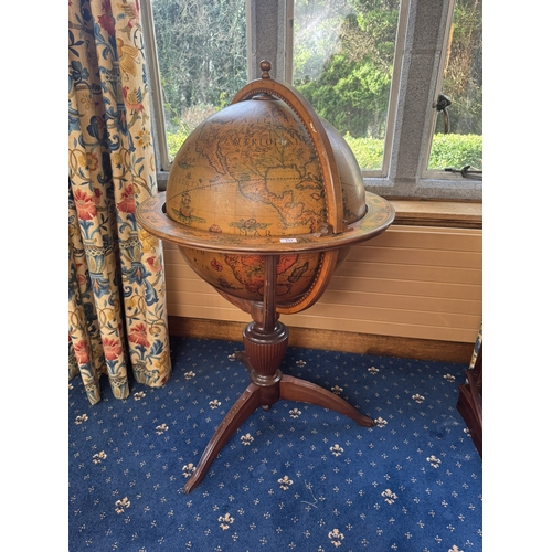 137 - Mahogany world globe drink's cabinet in the Regency style. {124 cm H x 74 cm Dia.{.