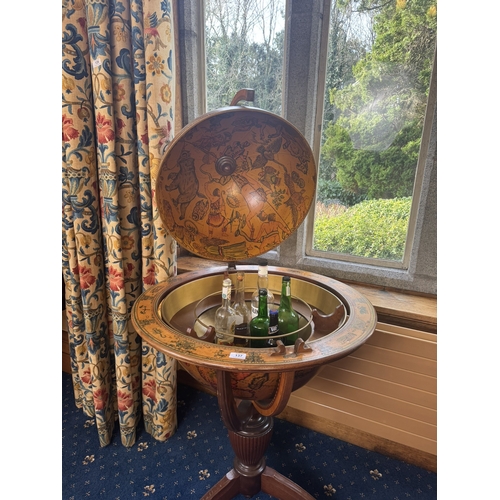 137 - Mahogany world globe drink's cabinet in the Regency style. {124 cm H x 74 cm Dia.{.