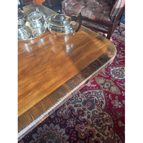 161 - Regency mahogany and crossbanded coffee table raised on four outswept feet and brass castors. {51 cm... 