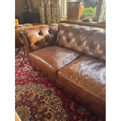 167 - Exceptional quality hand dyed leather deep buttoned Chesterfield sofa, raised on turned legs and bra... 