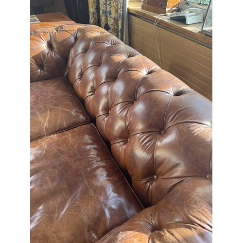 167 - Exceptional quality hand dyed leather deep buttoned Chesterfield sofa, raised on turned legs and bra... 