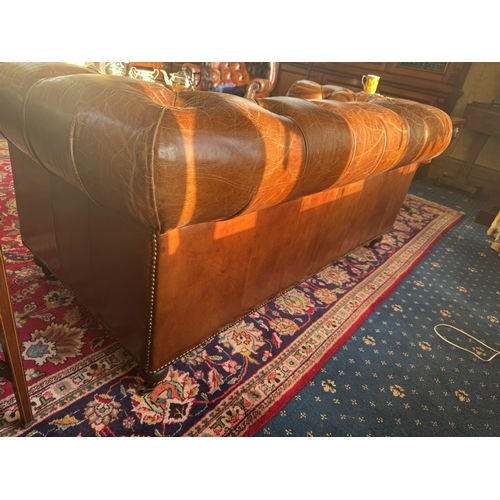 167 - Exceptional quality hand dyed leather deep buttoned Chesterfield sofa, raised on turned legs and bra... 