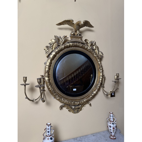 177 - 19th C. Irish Giltwood convex mirrror surmounted by eagle flanked by sconces and decorated with ivy ... 