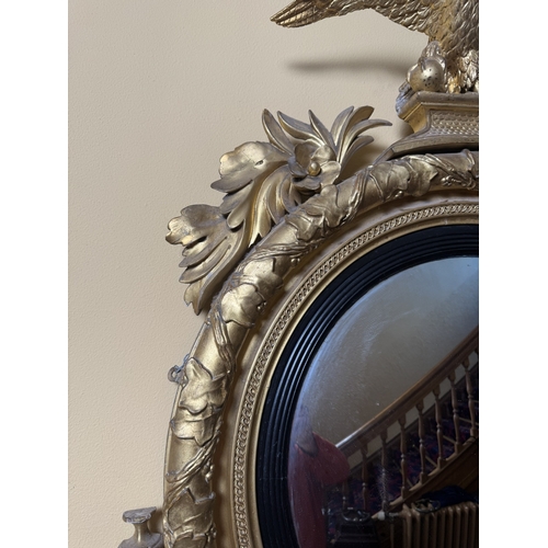 177 - 19th C. Irish Giltwood convex mirrror surmounted by eagle flanked by sconces and decorated with ivy ... 