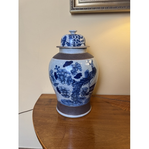 191 - Pair of blue and white Oriental lidded vases decorated with birds and foliage. {46 cm H x 27 cm Dia}... 