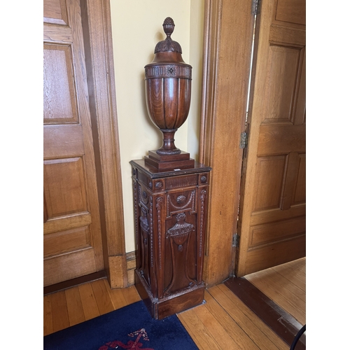 196 - Pair of carved mahogany urns, raised on pedestals in the Chippendale manner. {190 cm H x 41 cm W x 4... 