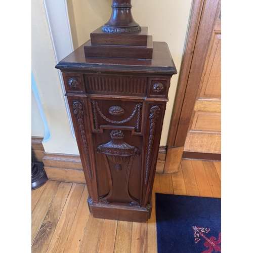 196 - Pair of carved mahogany urns, raised on pedestals in the Chippendale manner. {190 cm H x 41 cm W x 4... 