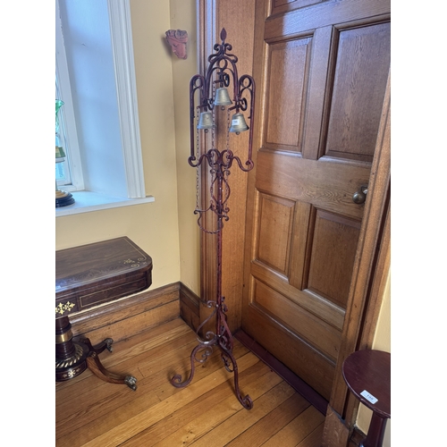 199 - Unusual decorative wrought iron house bell, raised on single column with tripod base. {176 cm H x 50... 