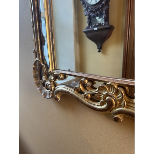 207 - Early 20th C. Italian giltwood wall mirror. {117 cm H x 76 cm W}.