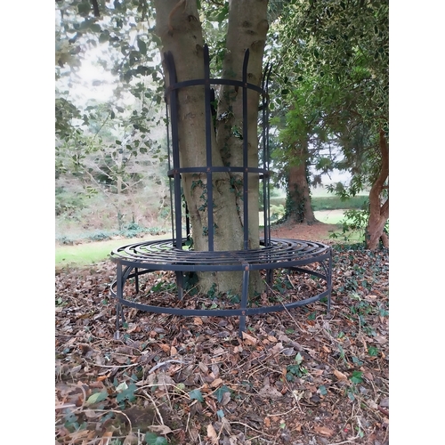 22 - Wrought iron circular tree surround bench with tree protector. {160 cm H x 150 cm Dia.}.