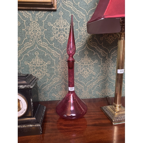 227 - Ruby glass decanter. {56 cm H x 18 cm Dia.}.