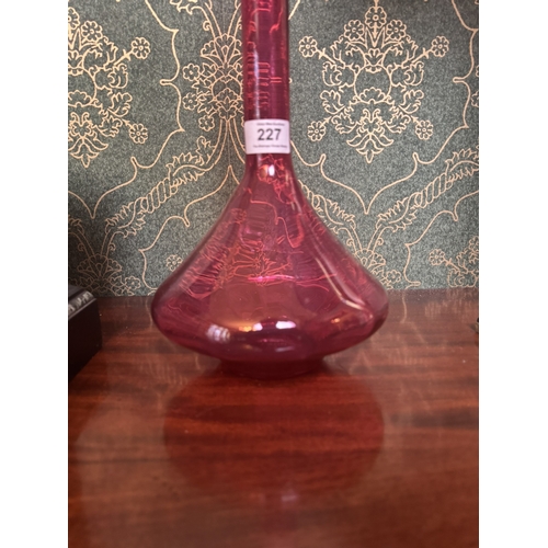 227 - Ruby glass decanter. {56 cm H x 18 cm Dia.}.