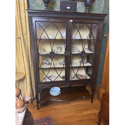 235 - Edwardian carved oak display cabinet with two astragal glazed doors, raised on square tapered legs. ... 