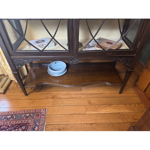 235 - Edwardian carved oak display cabinet with two astragal glazed doors, raised on square tapered legs. ... 