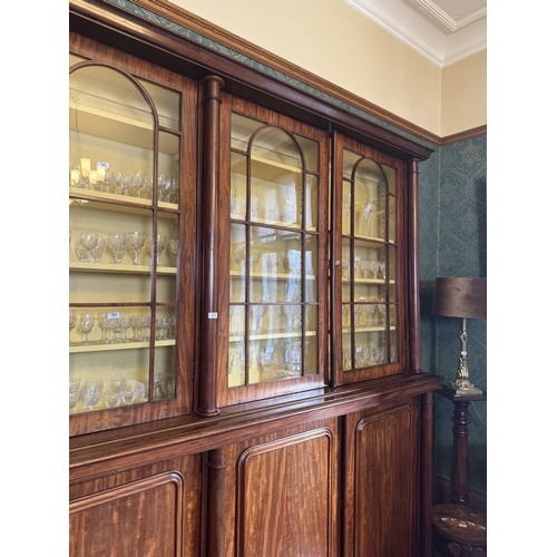 257 - Willliam IV mahogany four door glazed bookcase with turned columns above four blind doors, raised on... 