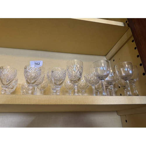 262 - Two shelves of miscellaneous cut crstal glasses.