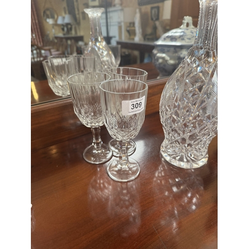 309 - Six moulded glass wine glasses and cut crystal decanter. {16 cm H} and {28 cm H}.