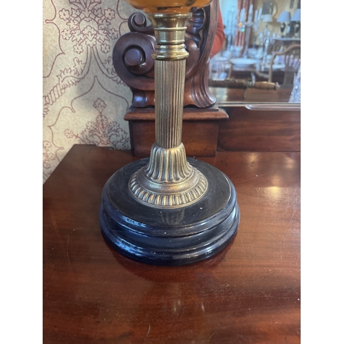 313 - Edwardian brass oil lamp with ruby glass shade. {67 cm H x 21 cm Dia.}.