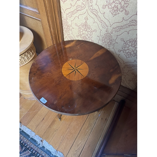 315 - Yew wood wine table, raised on turned column and three outswept feet, in the Regency style. {64 cm H... 