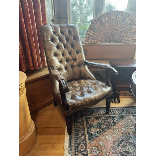 320 - Pair of good quality deep buttoned leather upholstered library chairs, raised on turned tapered legs... 