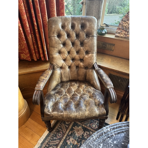 320 - Pair of good quality deep buttoned leather upholstered library chairs, raised on turned tapered legs... 