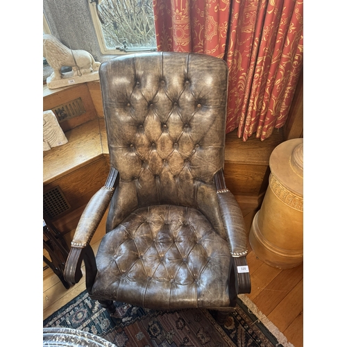 320 - Pair of good quality deep buttoned leather upholstered library chairs, raised on turned tapered legs... 