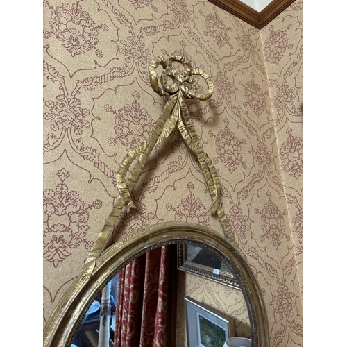 353 - Pair of Regency giltwood mirrors decorated with ribbons. {108 cm H x 60 cm W}.