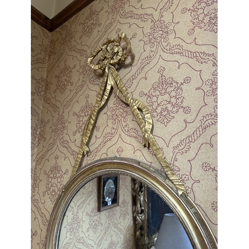 353 - Pair of Regency giltwood mirrors decorated with ribbons. {108 cm H x 60 cm W}.