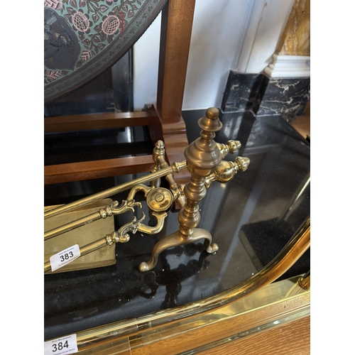 383 - Set of Edwardian brass fire irons and dogs. {28 cm H x 64 cm W}.