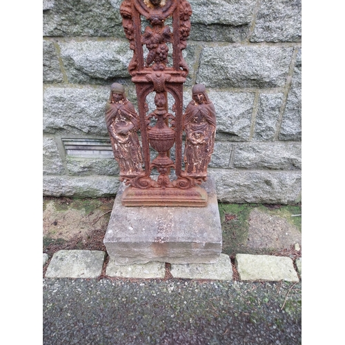 43 - 19th C. Decorative cast iron cross on limestone base. {196 cm H x 96 cm W x 38 cm D}.