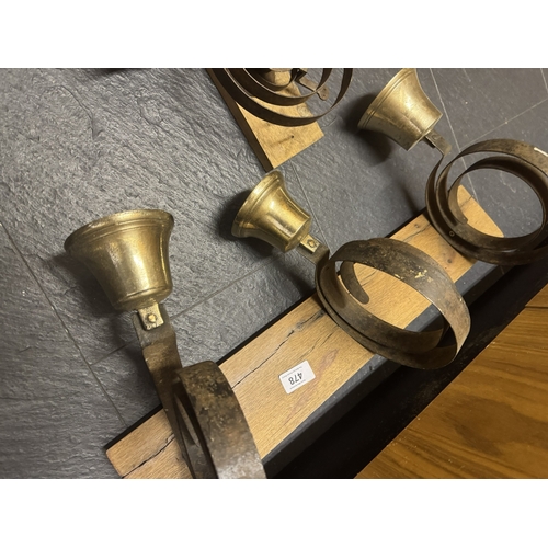 478 - Set of four brass house bells on oak plaques. {30 cm H x 59 cm W x 20 cm D}.