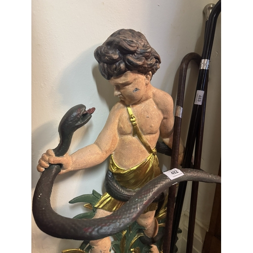 482 - Decorative cast iron stick stand depicting Cherub and Snake. {84 cm H x 47 cm W x 27 cm D}.