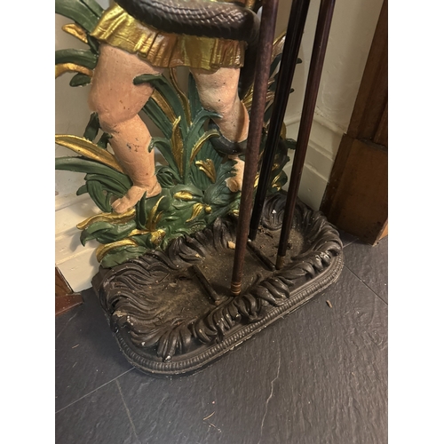 482 - Decorative cast iron stick stand depicting Cherub and Snake. {84 cm H x 47 cm W x 27 cm D}.