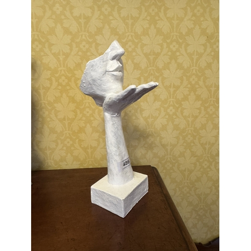 486 - Cast iron Kissing Hand sculpture. {31 cm H x 10 cm W  x14 cm D}.