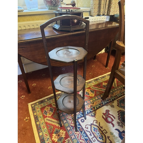 500 - Edwardian mahogany three tiered folding cake stand. {89 cm H x 28 cm W x 27 cm D}.