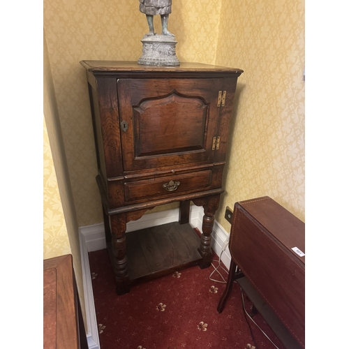 505 - Oak side cabinet with single door above single drawer, raised on turned legs and shelf in base. {114... 