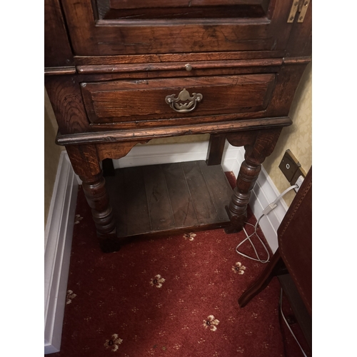 505 - Oak side cabinet with single door above single drawer, raised on turned legs and shelf in base. {114... 