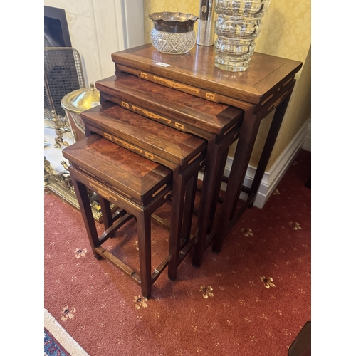 507 - Nest of four rosewood and burr walnut tables, in the Oriental manner. {60 cm H x 50 cm W x 35 cm D}.